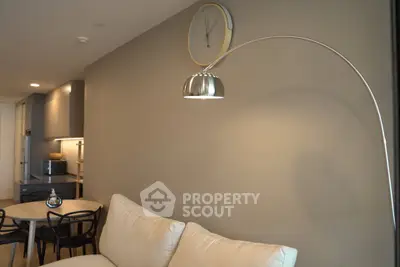 Modern living room with stylish lighting and cozy seating in a contemporary apartment.
