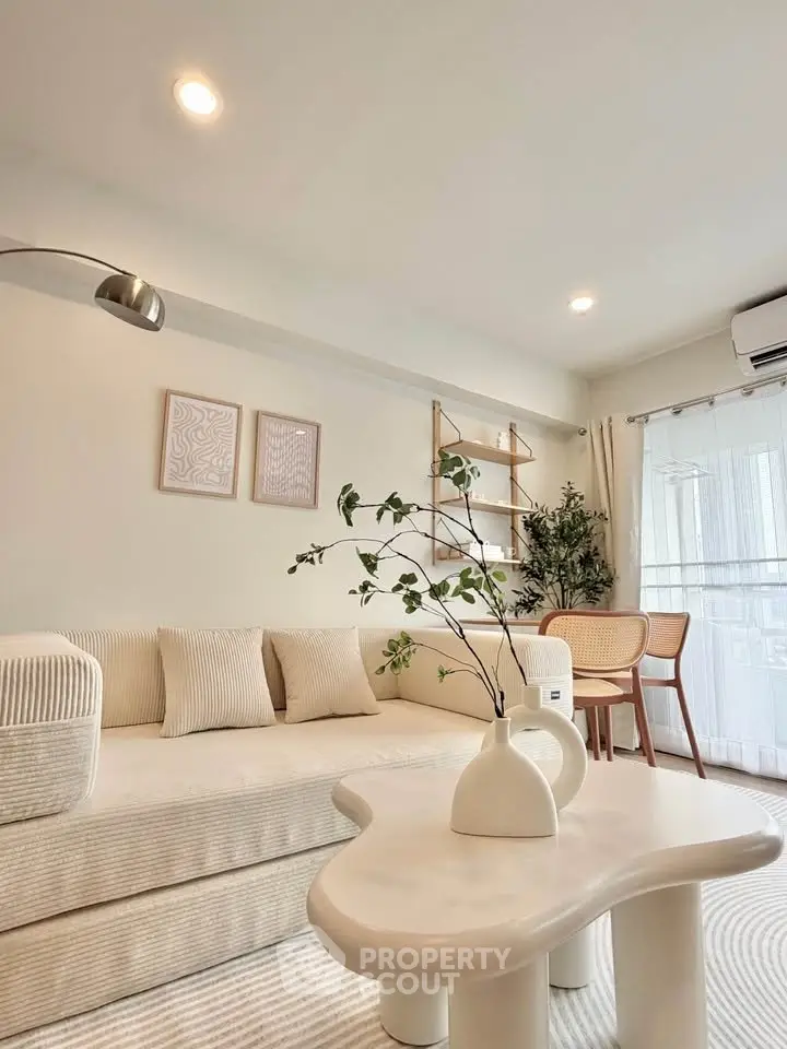 Stylish modern living room with cozy sofa and elegant decor, perfect for relaxation and entertaining.