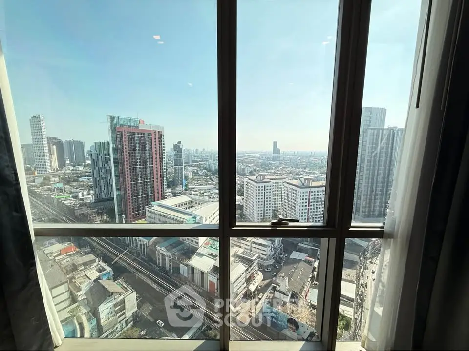 Stunning cityscape view from high-rise apartment window, showcasing urban skyline and vibrant city life.