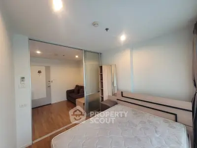 Spacious bedroom with sliding glass doors leading to cozy living area