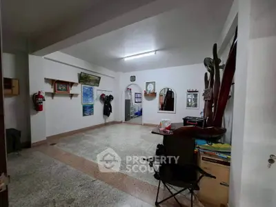 Spacious interior room with unique decor and ample natural light, ideal for versatile use.