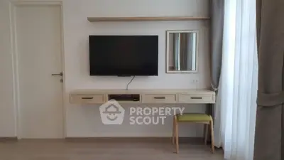 Modern minimalist living room with wall-mounted TV and stylish furniture