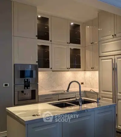 Luxurious modern kitchen with marble countertops and built-in appliances, perfect for gourmet cooking.