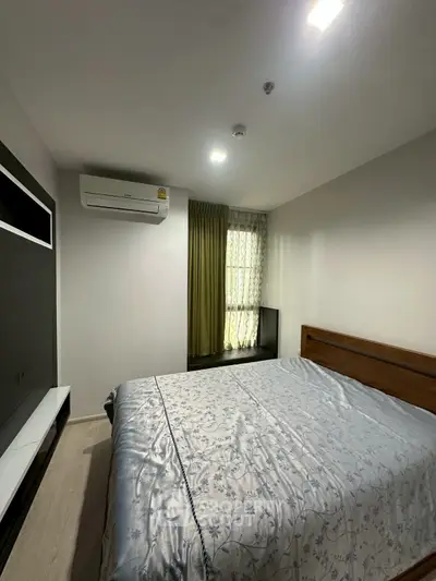 Cozy bedroom with modern air conditioning and elegant decor, perfect for relaxation and comfort.