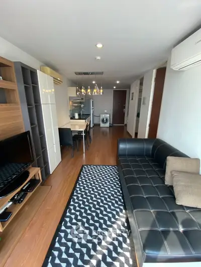 Modern living room with stylish furniture and open kitchen layout