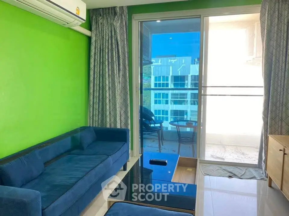 Modern living room with vibrant green walls and balcony view