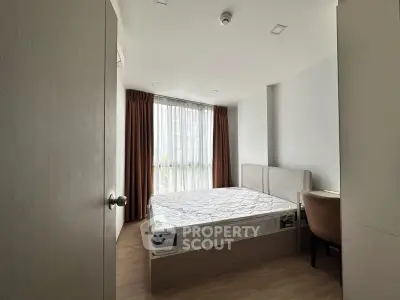 Modern bedroom with large window and minimalist design in urban apartment