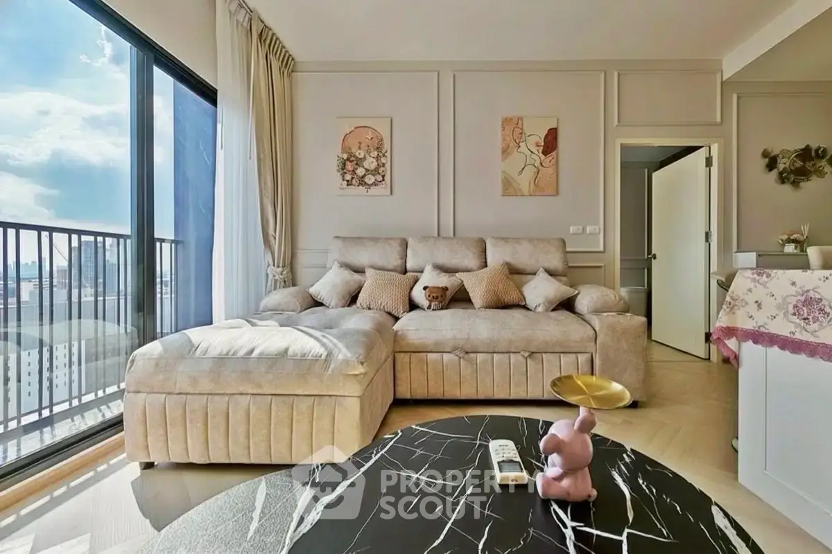 Luxurious living room with plush sofa and city view balcony, perfect for relaxation and entertaining.