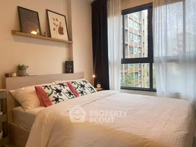 Cozy bedroom with large window and modern decor in urban apartment