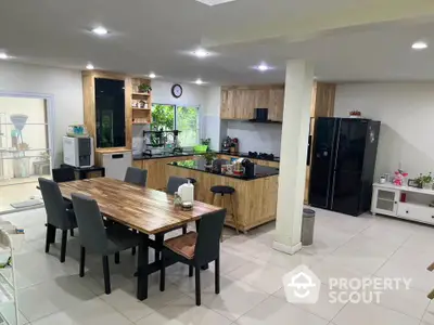 Spacious modern kitchen with dining area and sleek appliances