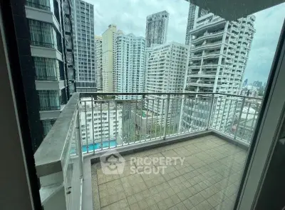 Spacious balcony with stunning cityscape views in a modern high-rise building.