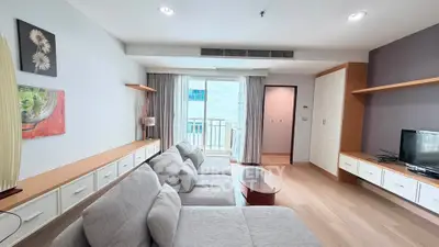 Spacious modern living room with cozy gray sofa and stylish decor in a bright apartment.