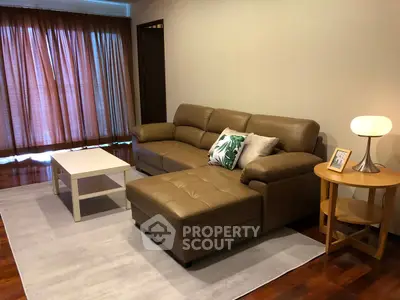 Cozy living room with brown leather sofa and modern decor