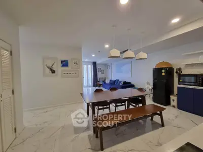 Spacious open-plan living and dining area with modern decor and ample natural light.
