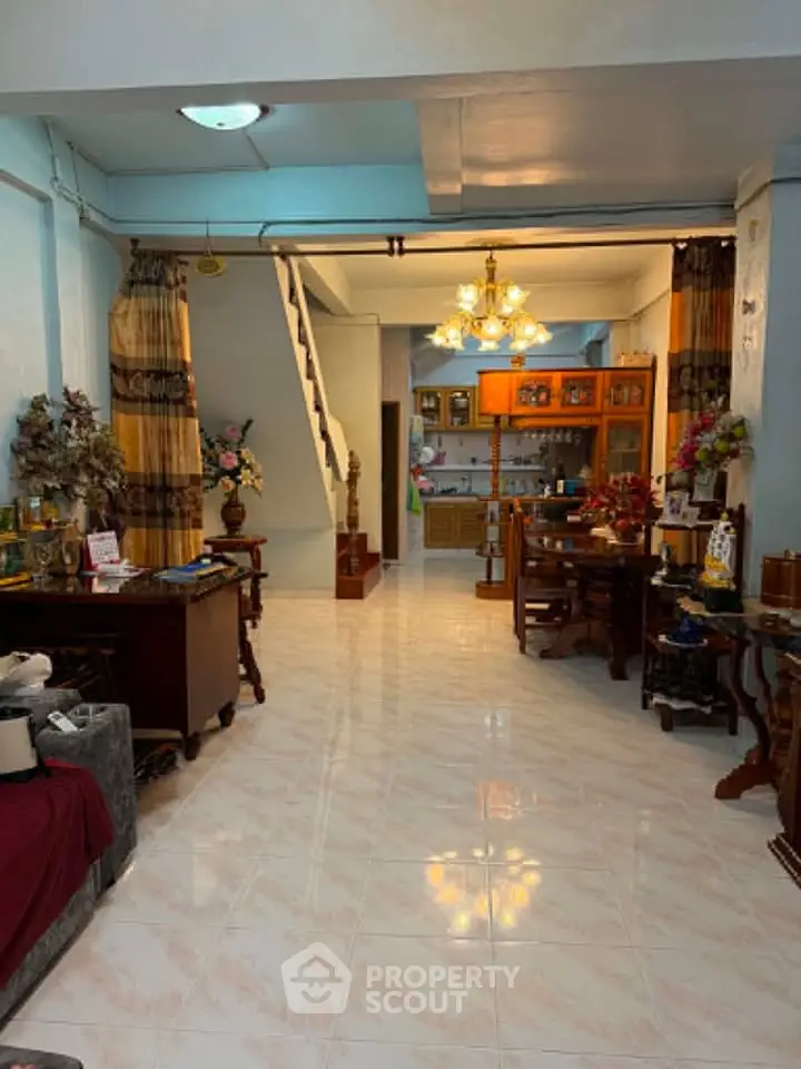 Spacious living room with elegant decor and open layout, featuring a dining area and stylish lighting.
