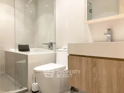 Modern bathroom with sleek design, featuring a bathtub and elegant fixtures.