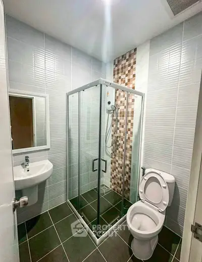 Modern bathroom with glass shower enclosure and sleek tile design