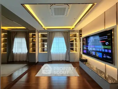 Luxurious living room with modern entertainment system and elegant lighting.