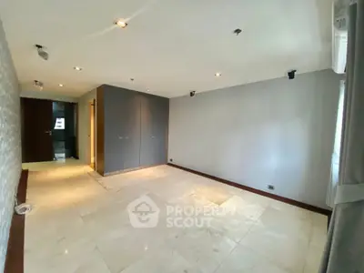 Spacious unfurnished room with modern lighting and large closet, ideal for customization.