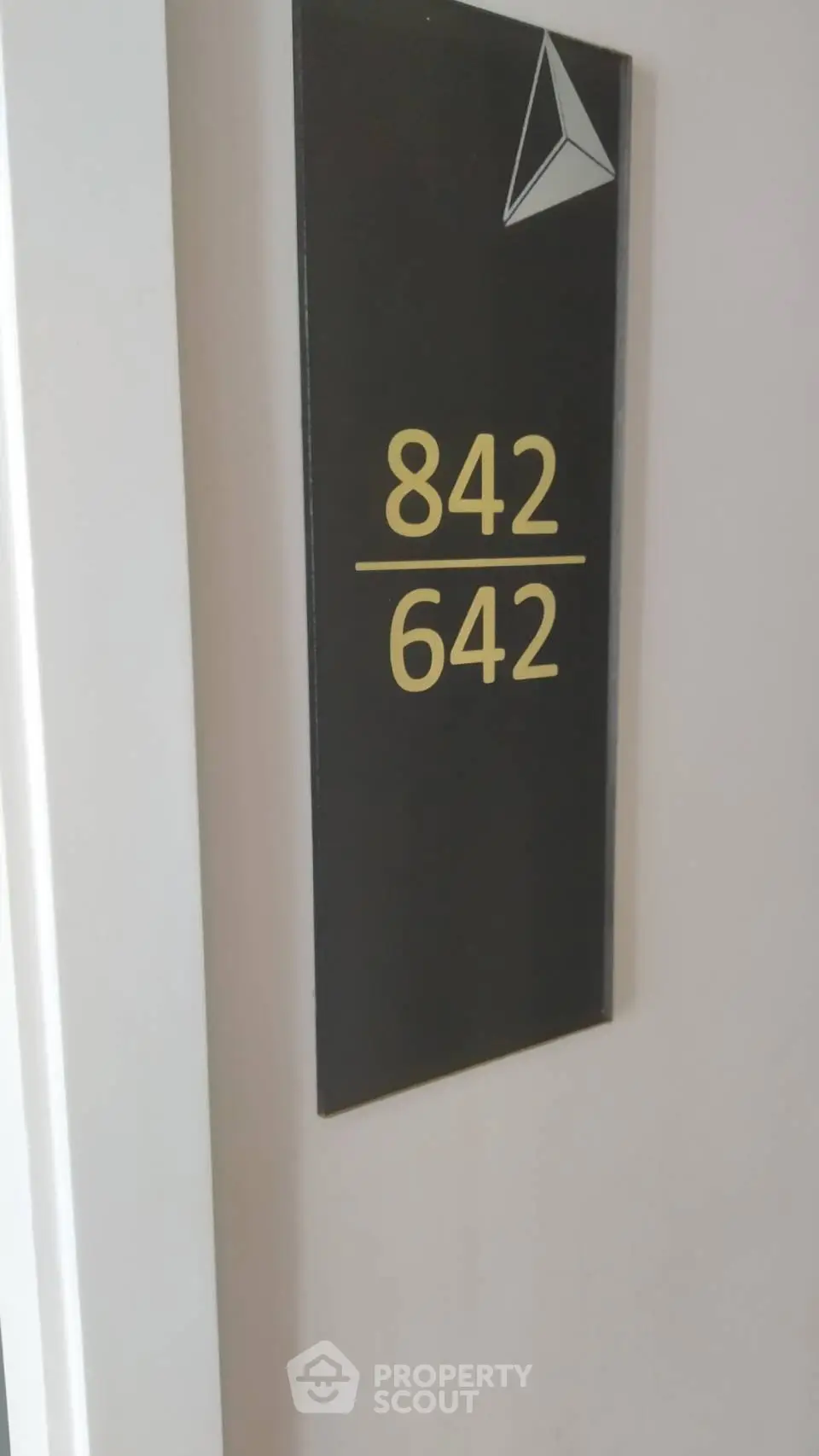 Modern apartment door number sign with sleek design
