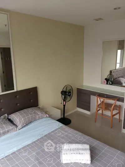 Cozy bedroom with modern decor and a stylish vanity area