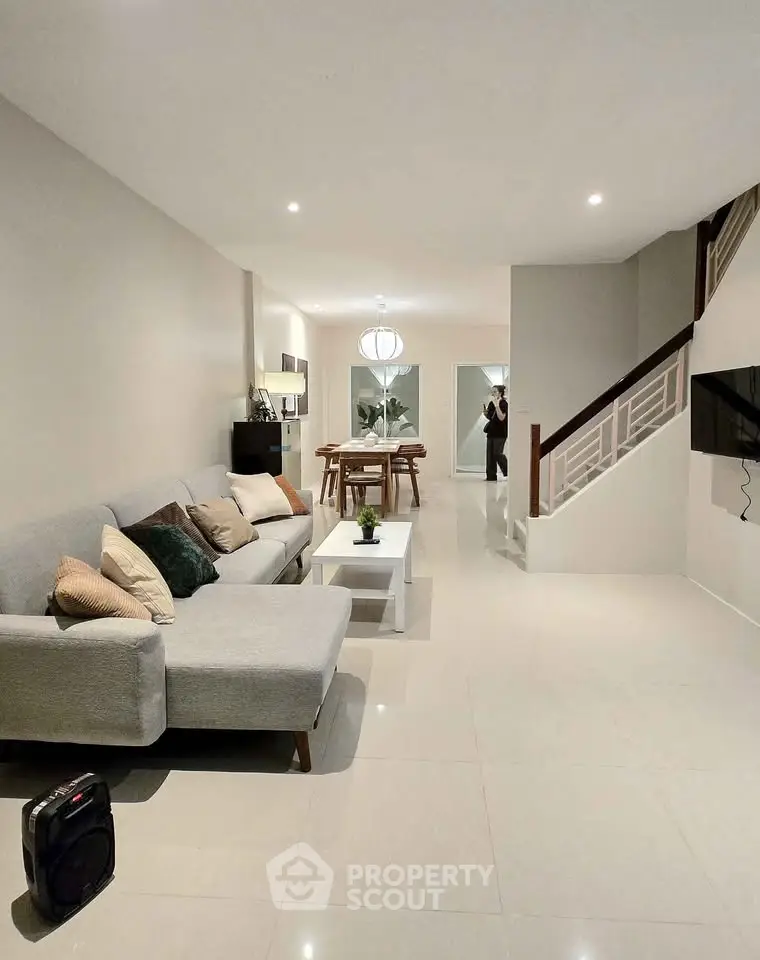 Spacious modern living room with elegant decor and open dining area.