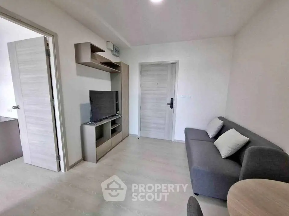 Modern living room with sleek furniture and neutral tones, perfect for cozy urban living.