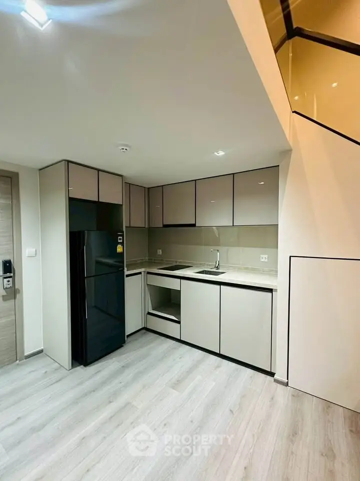 Modern kitchen with sleek cabinetry and integrated appliances in a stylish apartment