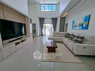 Spacious modern living room with high ceilings and large windows