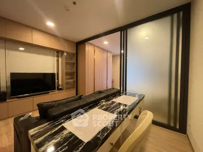 Modern living room with sleek black marble dining table and cozy seating area.