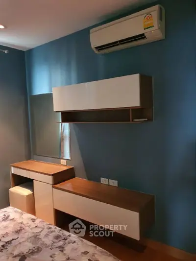 Modern bedroom with stylish furniture and air conditioning unit