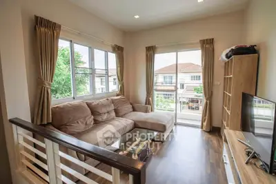 Bright and cozy living room with large windows and modern furnishings in a stylish home.
