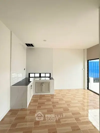 Spacious modern kitchen with open layout and stylish tile flooring