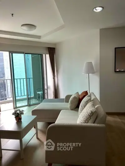 Modern living room with cozy sofa and balcony view in urban apartment