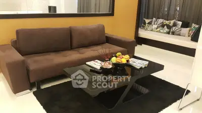 Stylish living room with modern brown sofa and sleek black coffee table