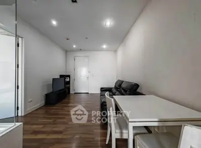 Spacious modern living room with sleek furniture and wooden flooring, perfect for relaxation and entertainment.