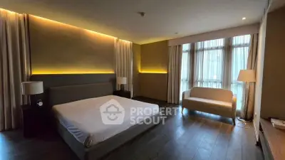 Luxurious bedroom with modern lighting and large windows in upscale apartment