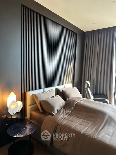 Luxurious modern bedroom with elegant decor and ambient lighting, featuring a stylish headboard and cozy bedding.
