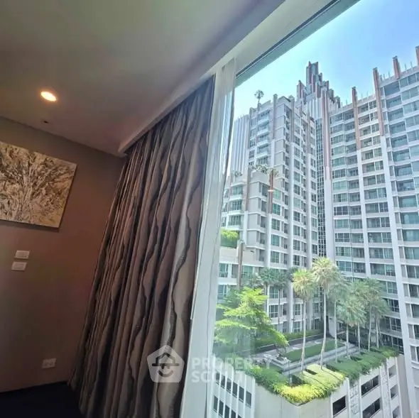 Luxurious high-rise apartment view with modern architecture and lush greenery.