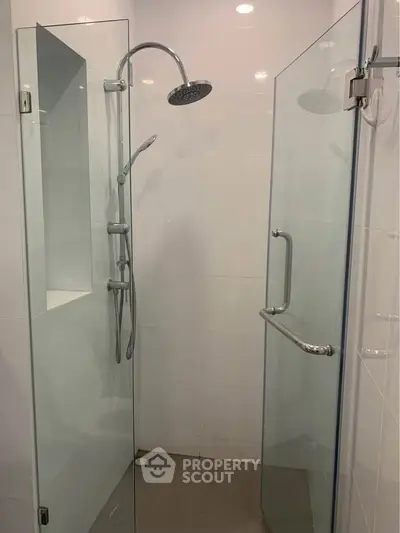 Modern glass shower enclosure with sleek fixtures in a contemporary bathroom.