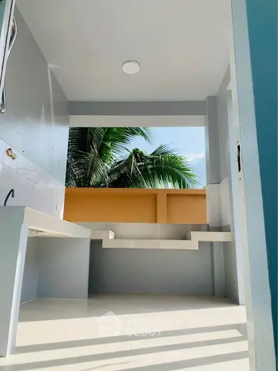 Modern open-air kitchen with tropical view and sleek design