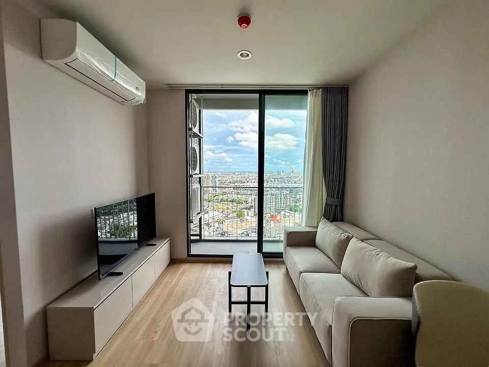 Modern living room with panoramic city view, featuring sleek furniture and large windows for natural light.
