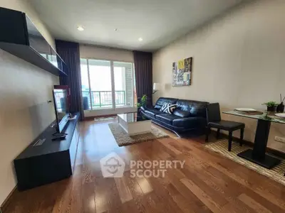 Spacious modern living room with hardwood floors and balcony view