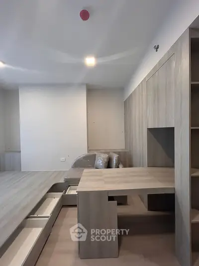Modern minimalist living room with built-in storage and sleek wooden furniture
