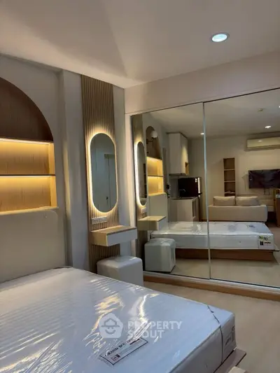 Modern bedroom with mirrored wardrobe and stylish lighting