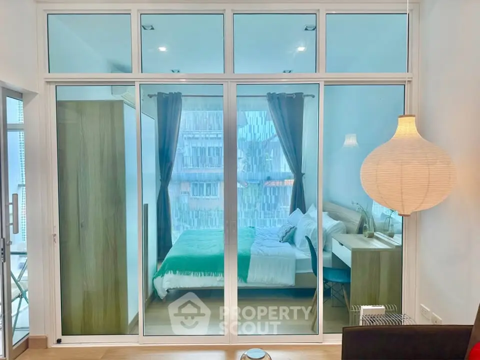 Modern bedroom with glass partition and stylish decor in urban apartment