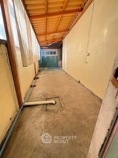 Spacious covered outdoor area with potential for customization in a residential property.