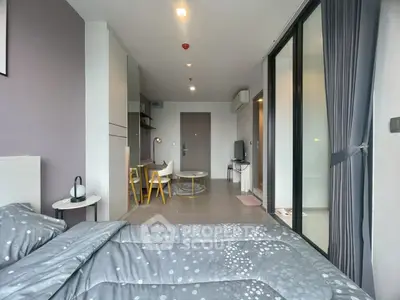 Modern studio apartment with stylish decor and open layout, featuring a cozy bed and dining area.