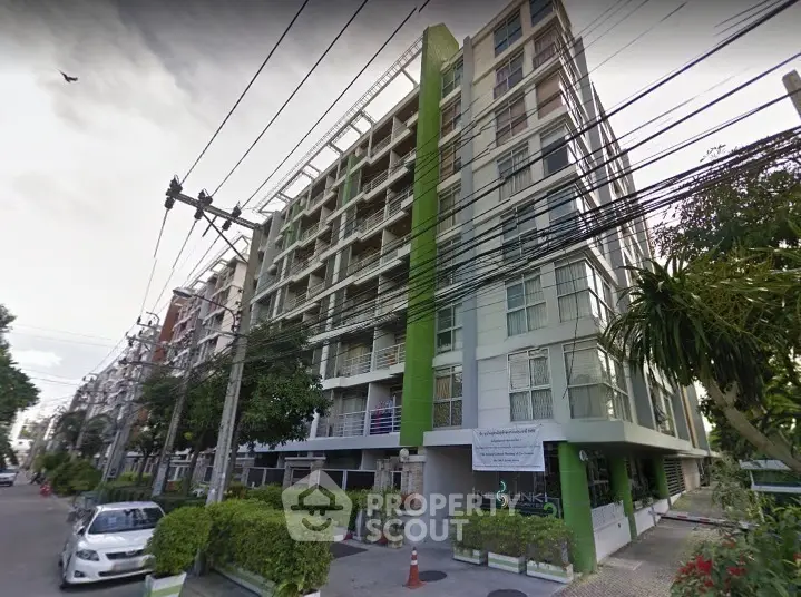 Modern urban condominium with green accents and lush surroundings