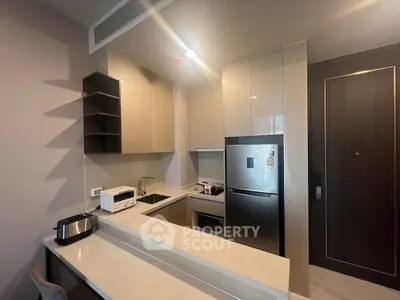 Modern kitchen with sleek appliances and open layout in stylish apartment